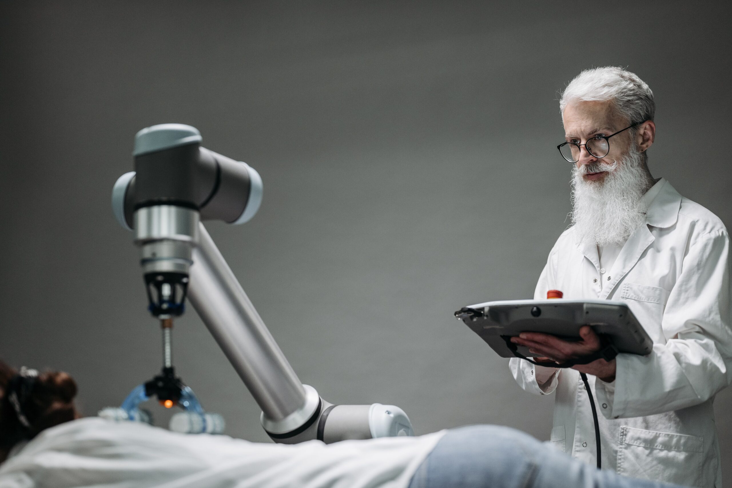 Older adult cancer patient discussing an experimental AI-designed immunotherapy with an oncologist in a modern cancer clinic