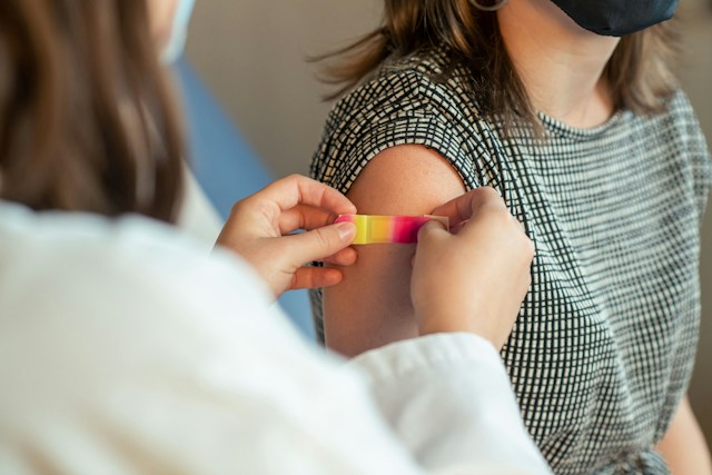 Healthcare professional preparing an MMR measles vaccine dose in a clinical setting