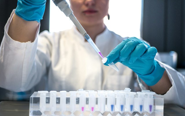 Medical blood collection tubes beside a laboratory test requisition form