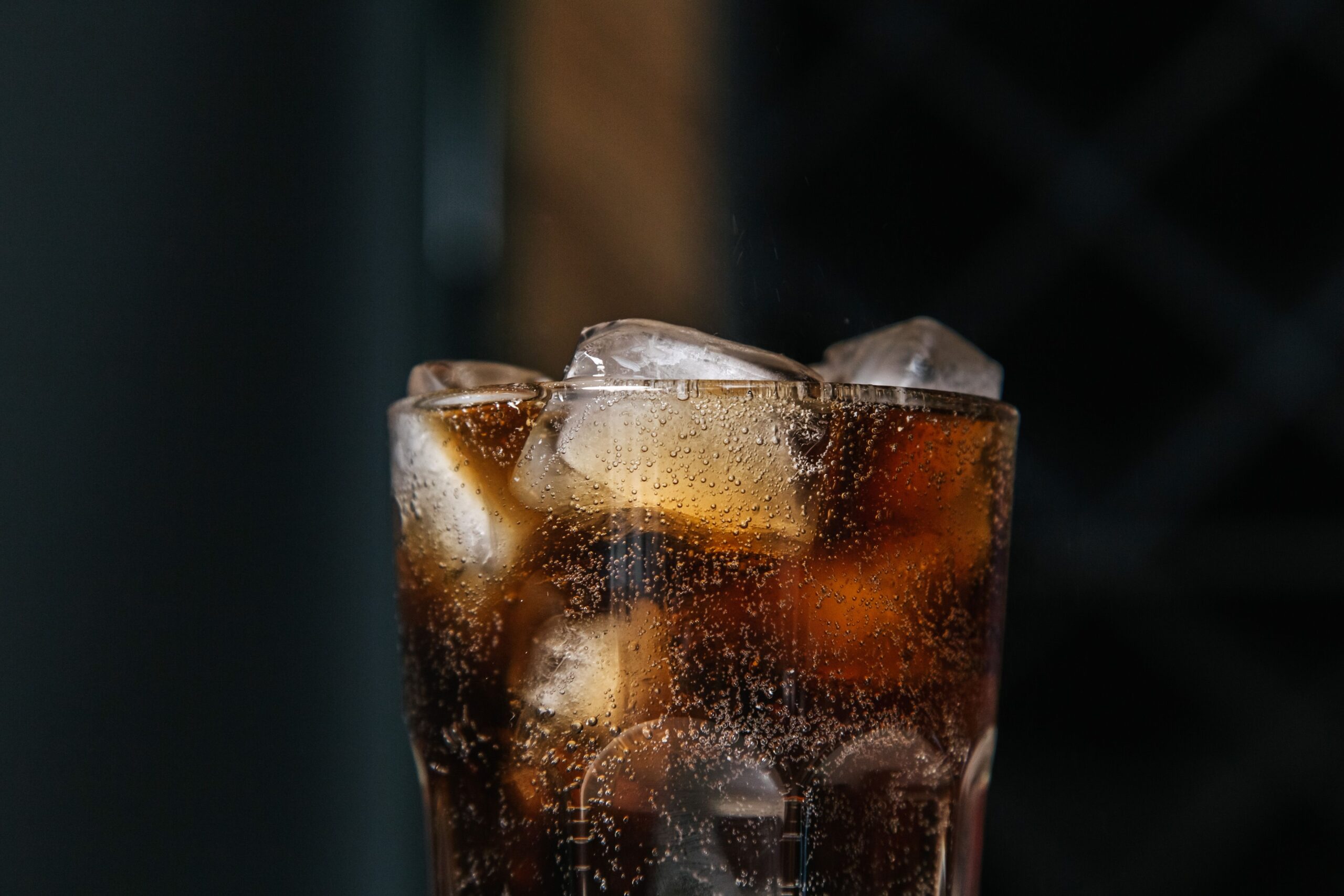 Older adult choosing water instead of a sugar-sweetened beverage at a kitchen table