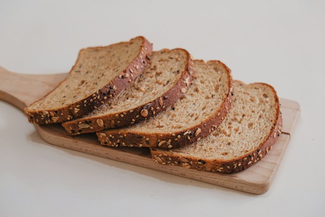 Oats, quinoa, brown rice and whole-wheat grains arranged in bowls
