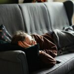 Adult resting comfortably during a short afternoon nap in a quiet, softly lit room.