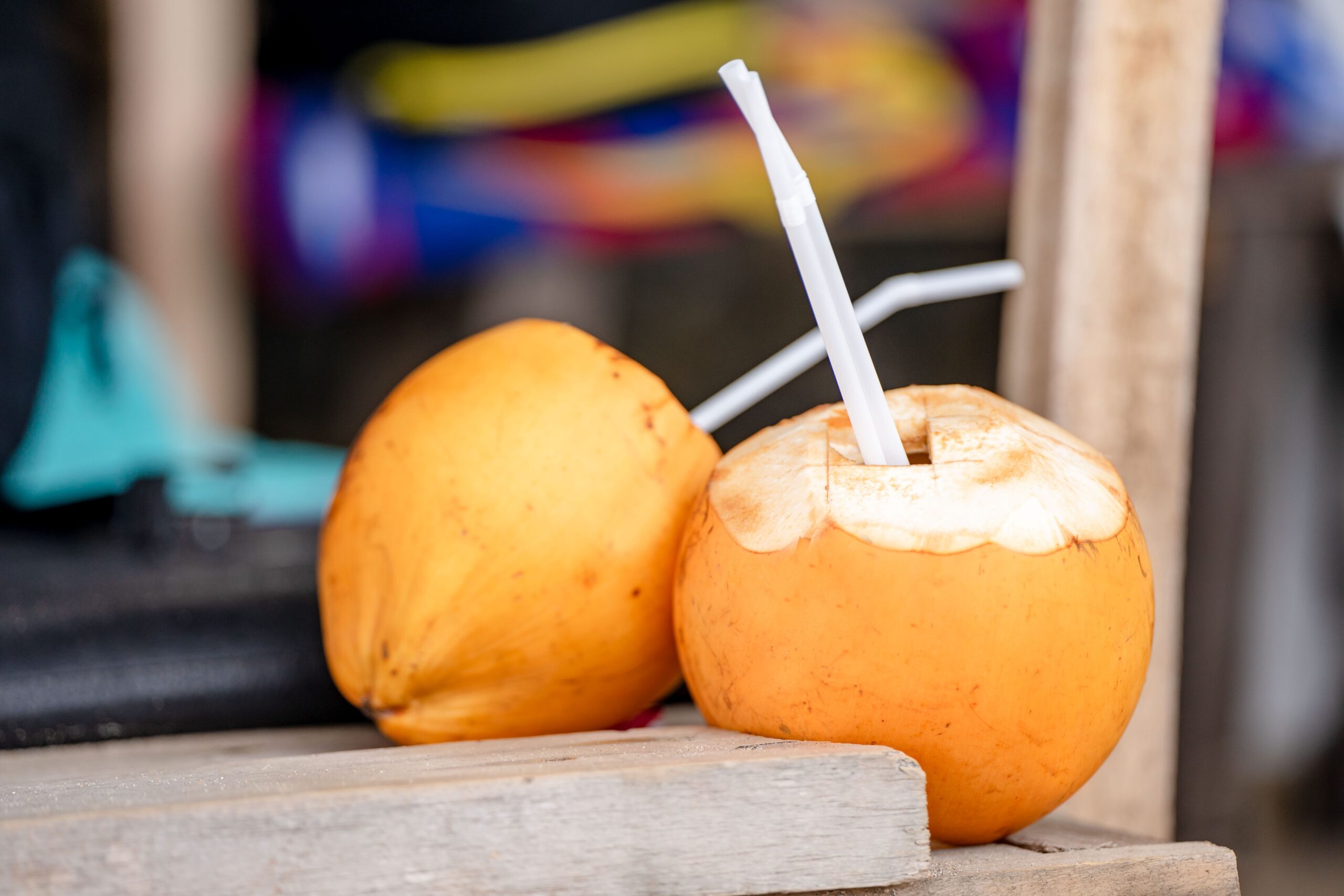 A glass of fresh coconut water with a cut coconut illustrating hydration and kidney health
