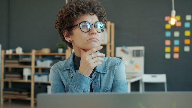 Person reflecting quietly while exploring the connection between self-talk, stress and mental health